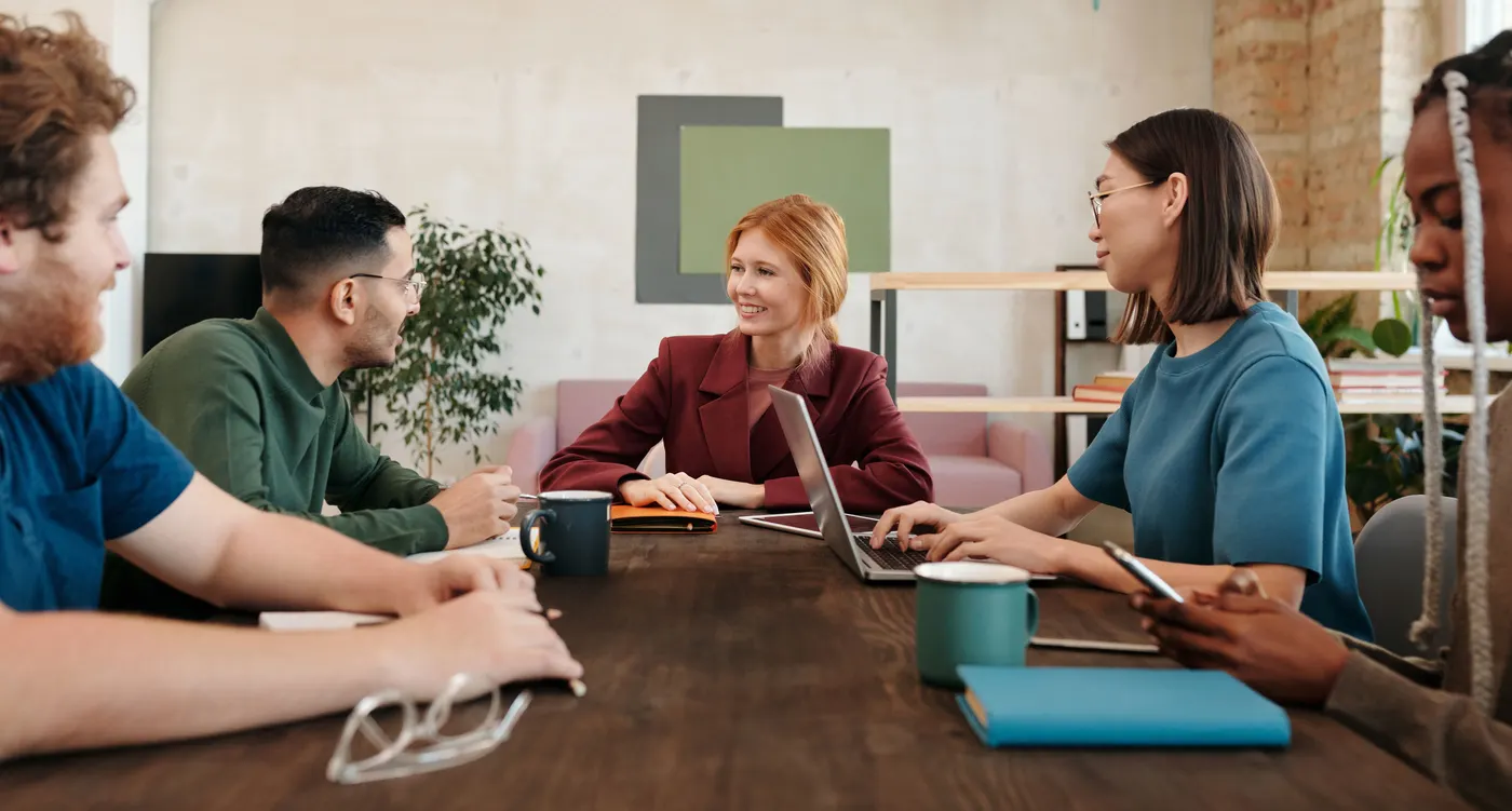 SEO Kitchener team discussing a client strategy around a meeting table